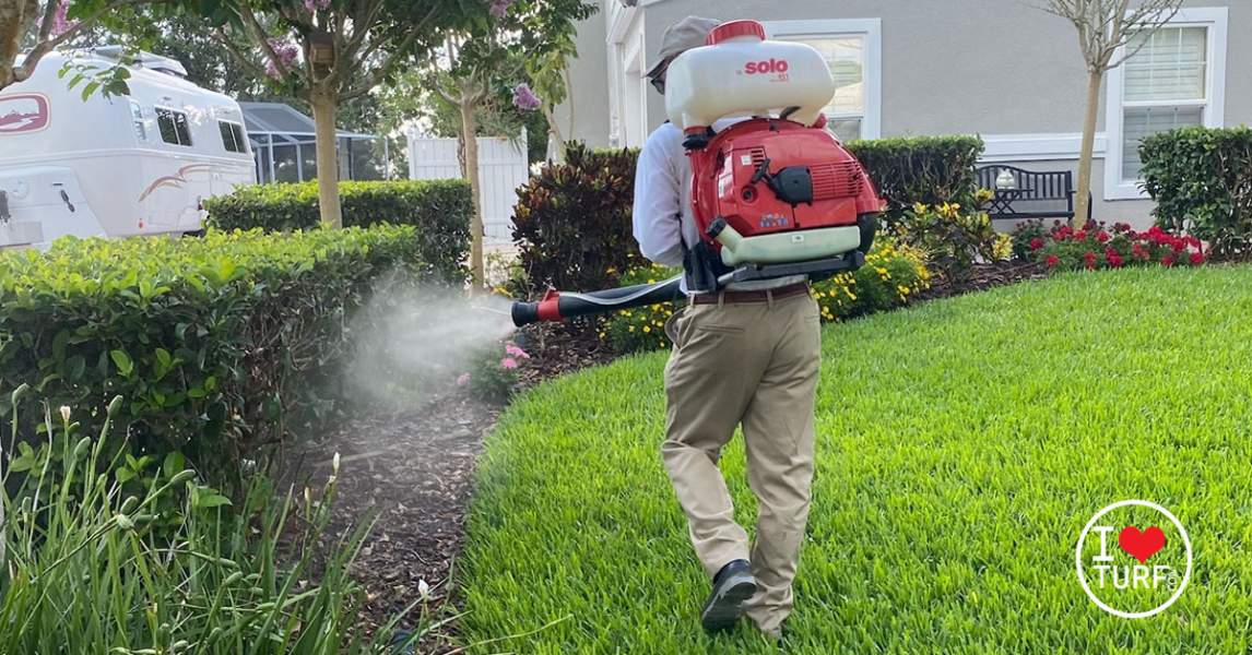 MAn using a fogger to combat mosquitos in the landscape